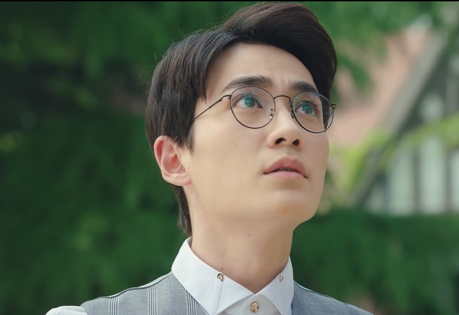 A man in glasses looks up.